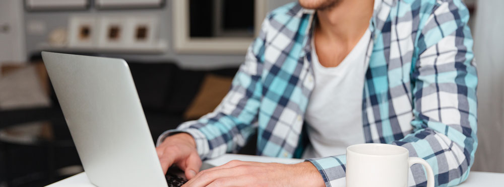 Man with laptop reading about leadership